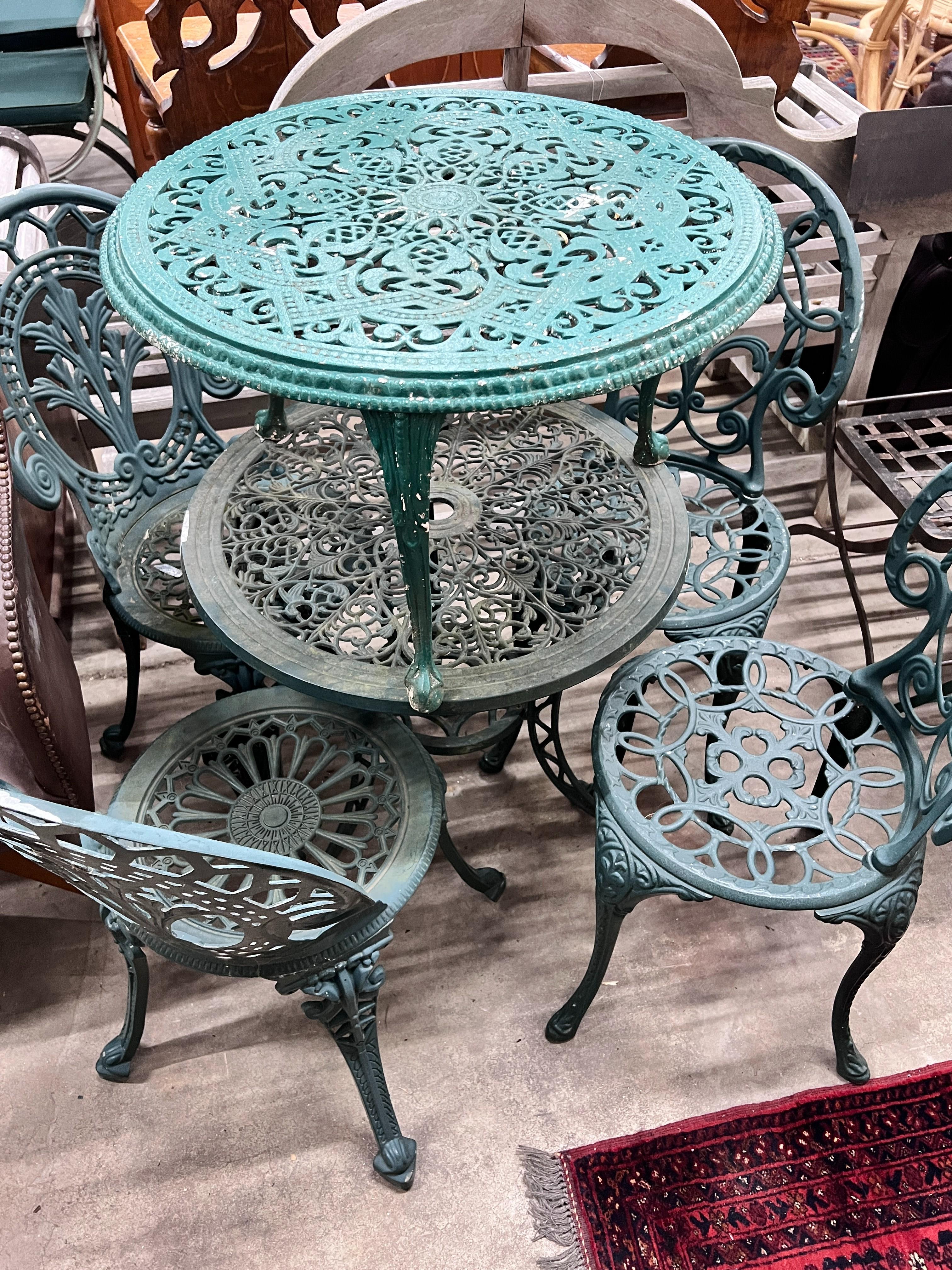 A Victorian style painted aluminium circular garden table, four chairs and a low garden table, larger diameter 60cm, height 63cm